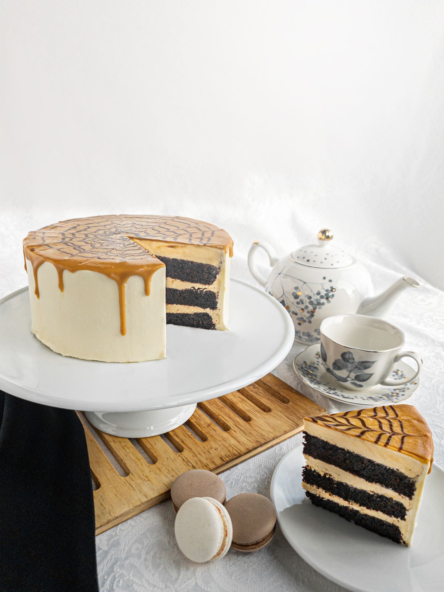Beautifully displayed butterscotch fudge cake with macaroons and tea at The Kingsbury Hotel