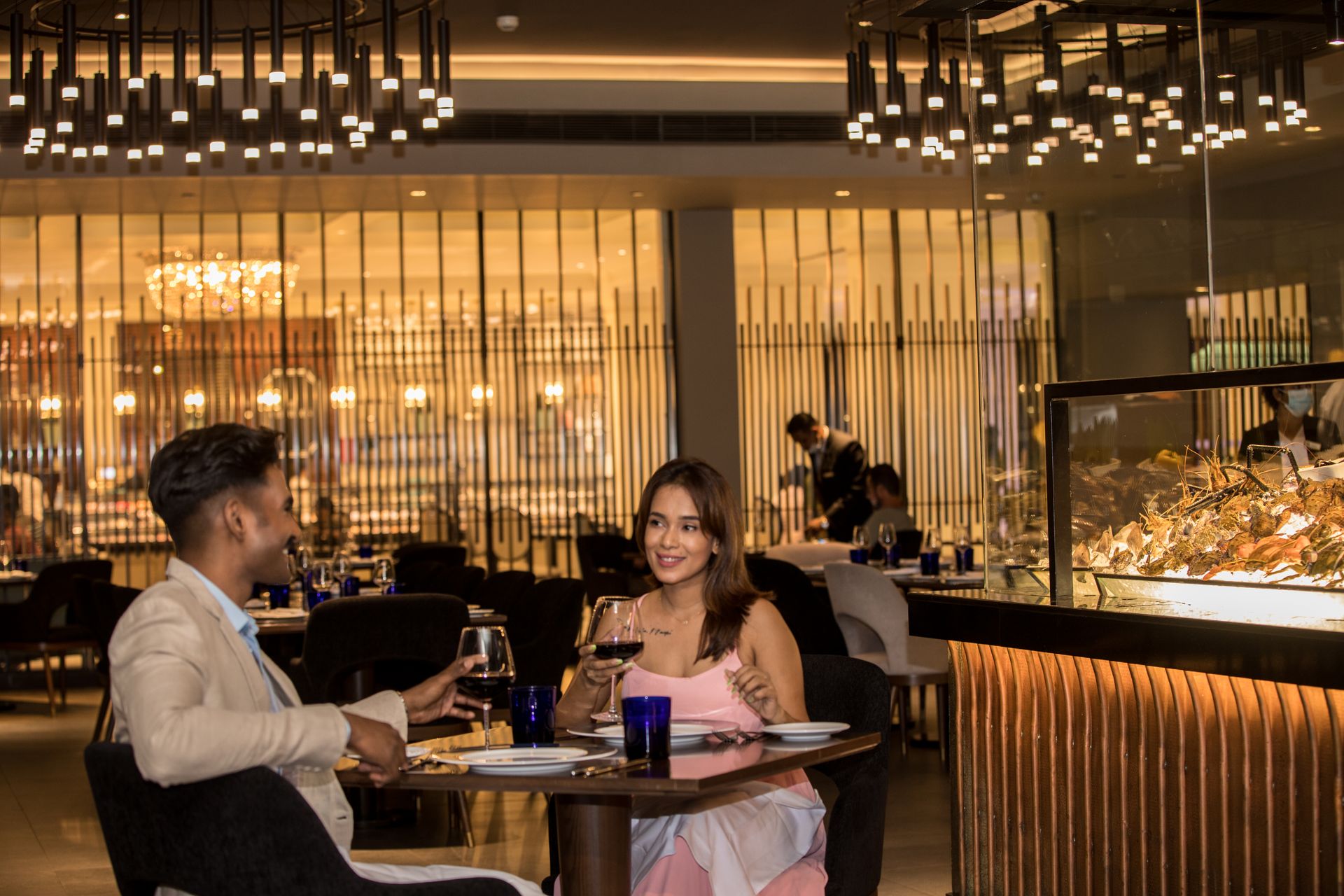 Couple enjoying wine at the Ocean Seafood restaurant at The Kingsbury Hotel