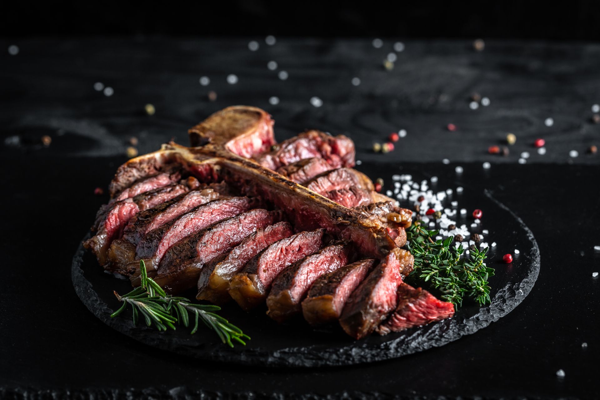 Thinly sliced steak on a plate with herbs and spices at The Kingsbury Hotel