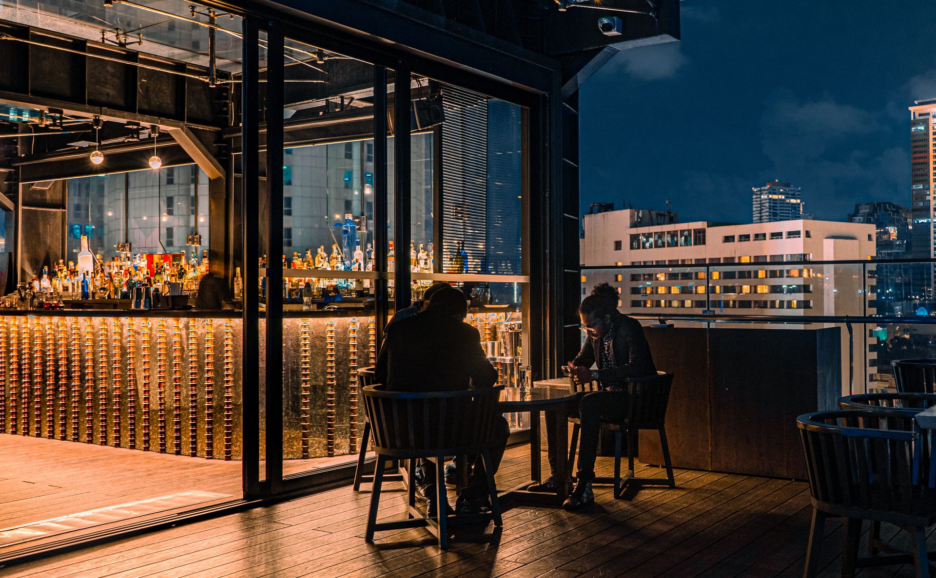A group of friends enjoying drinks at Sky Lounge rooftop bar at The Kingsbury Hotel
