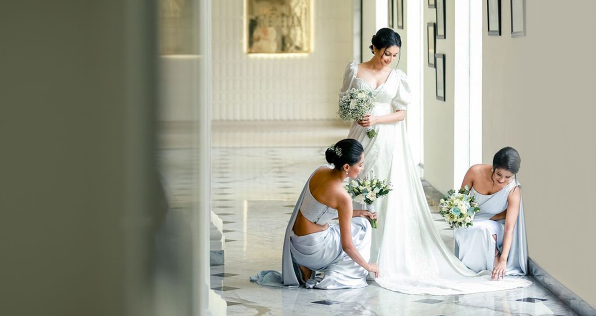 Two brides mates fixing the brides gown at The Kingsbury Hotel