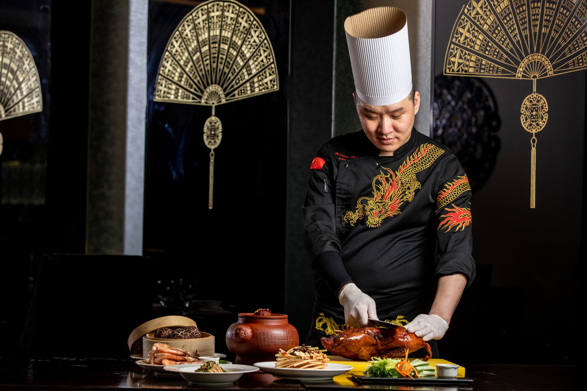 A chef cutting food in the Yue Chuan Restaurant at The Kingsbury Colombo