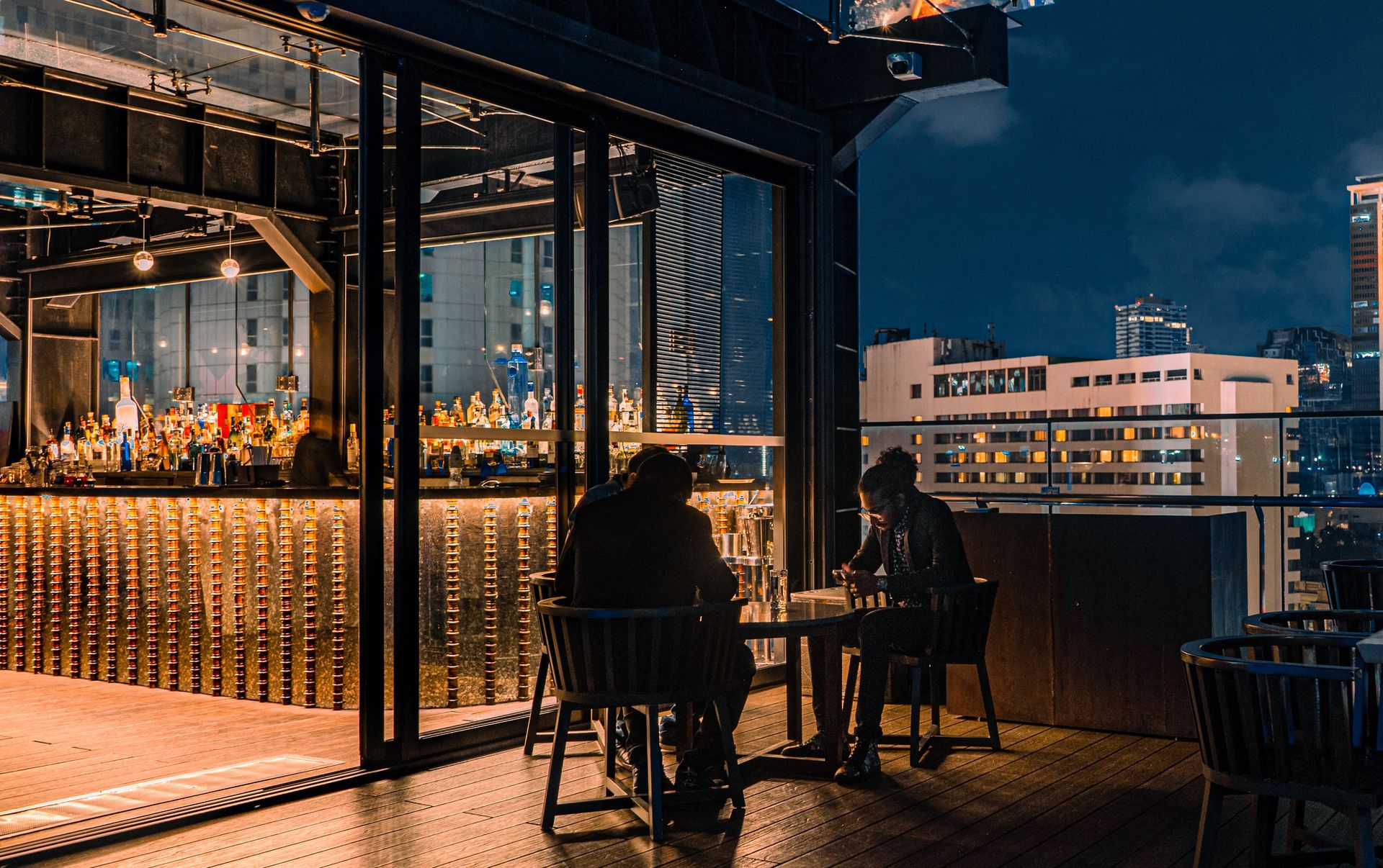 People sitting in the balcony of the Sky Lounge at The Kingsbury Colombo