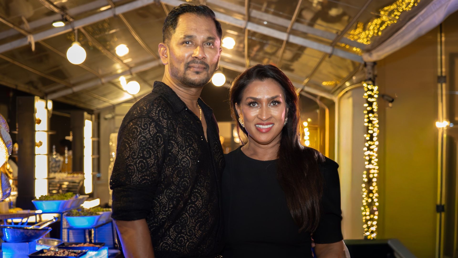 A couple posing for a photo at an event