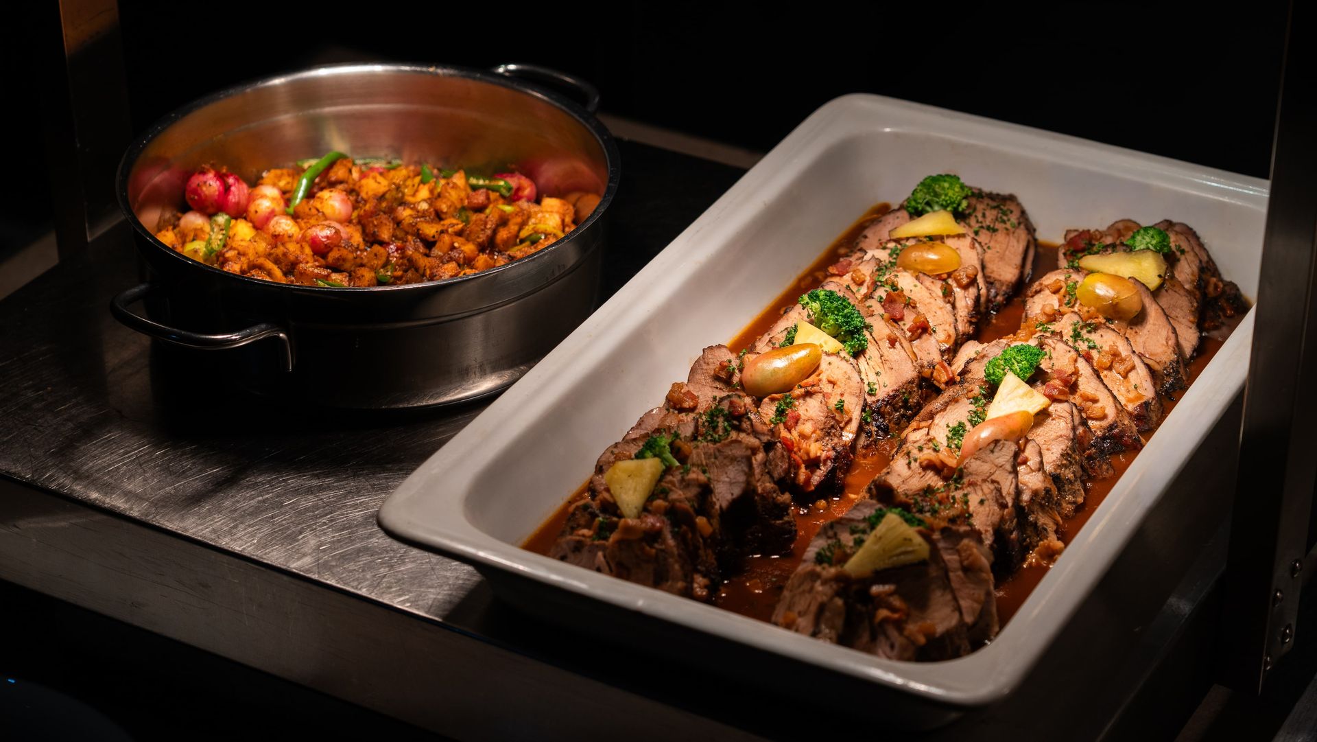 A meat dish sliced and served in a white rectangular tray