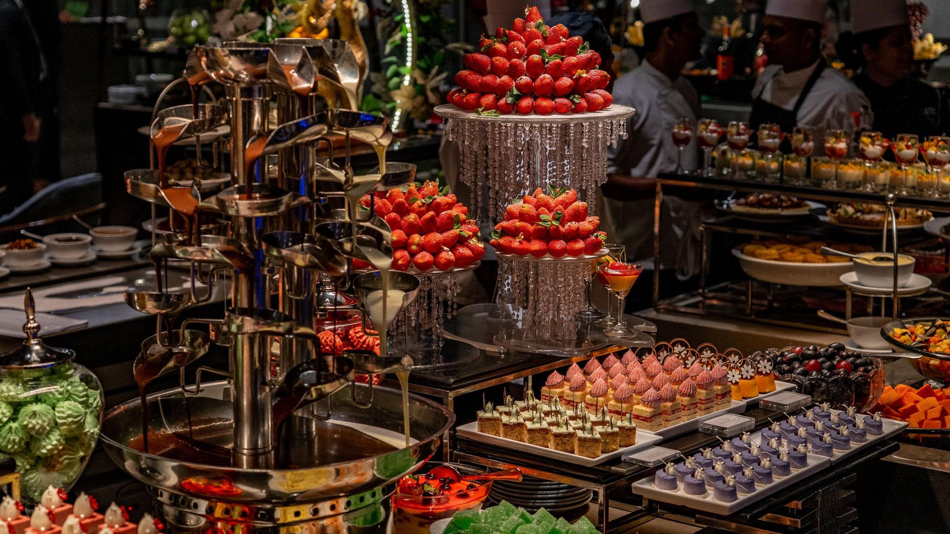 Dessert buffet with strawberries, chocolate fountains, and assorted desserts