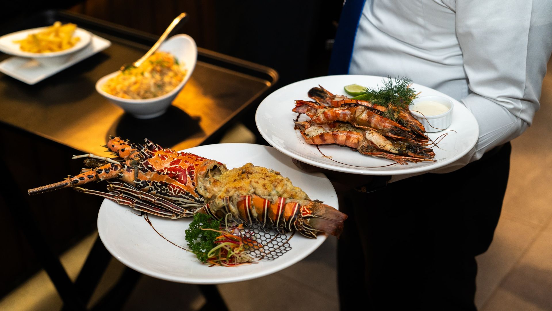 Lobster meat with herbs and grilled prawns garnished with lime and dill