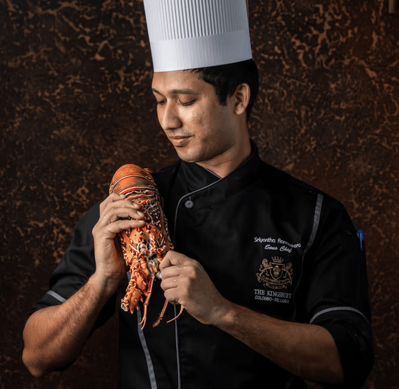 A chef holding a lobster